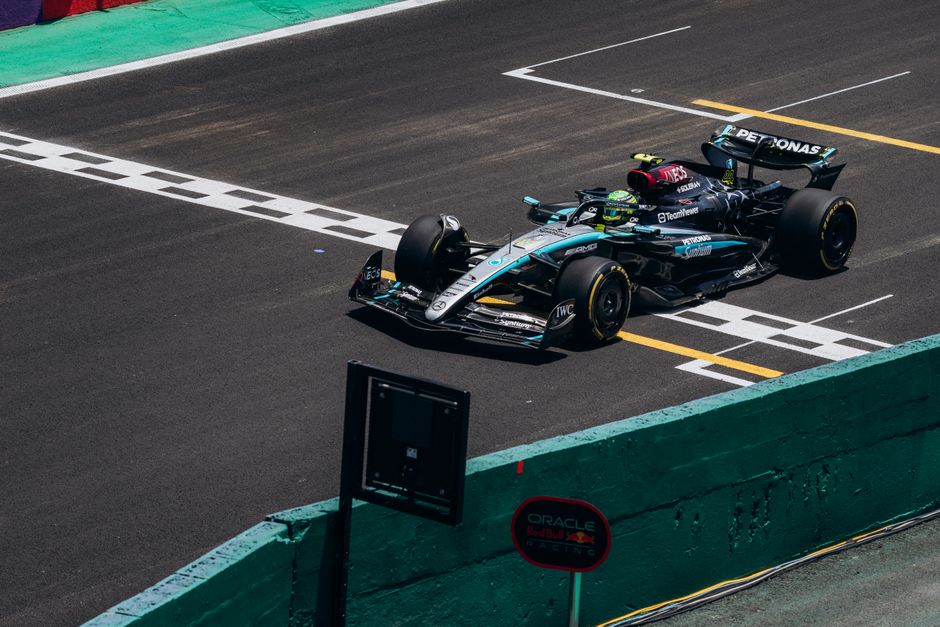 Podium celebration or tire marks on track, capturing speed blur and race intensity.