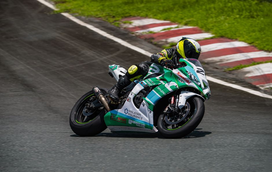 Close-up or wide shot — podium, tire marks, speed blur