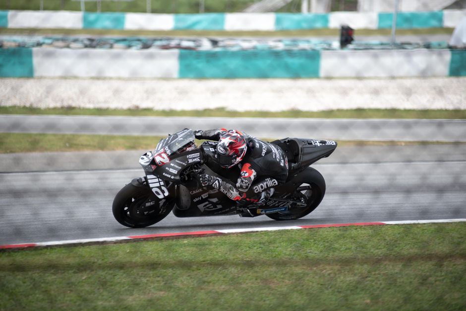 Podium celebration with riders, tire marks, speed blur