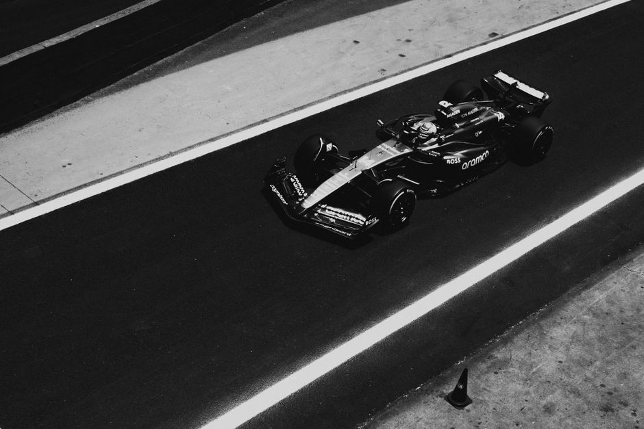 Pit lane activity during a race, team mechanics in action
