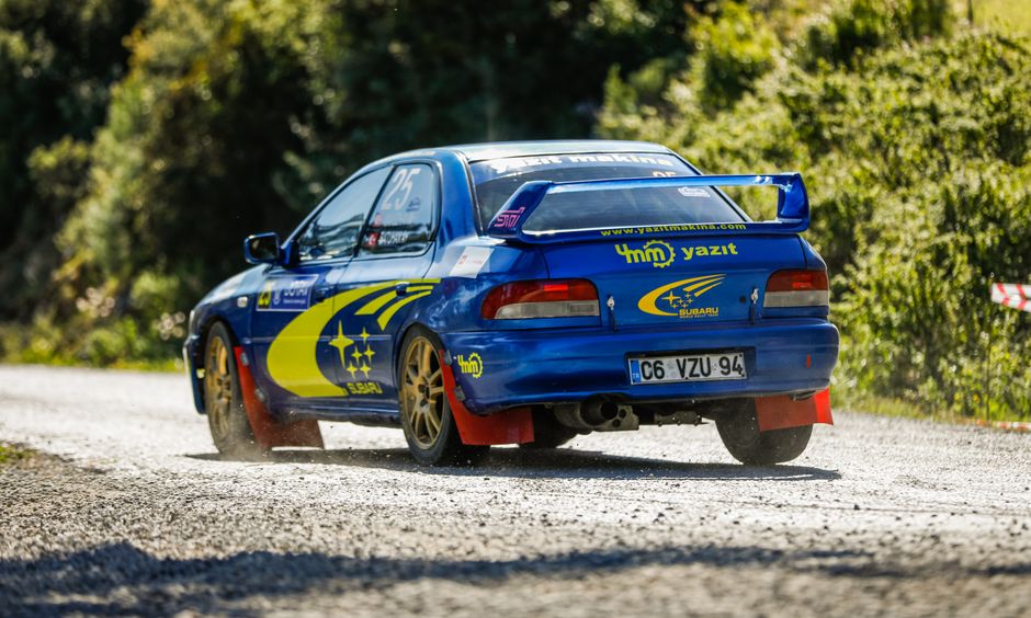 Wide shot of rally podium, tire marks and speed blur in the foreground