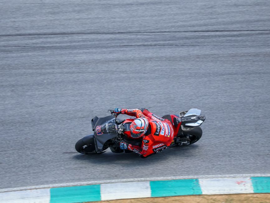 Podium close-up, tire marks, speed blur at Mandalika