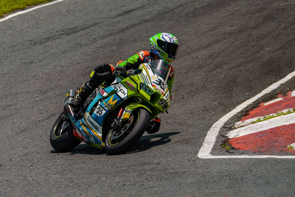Podium celebration, tire marks on track, speed blur