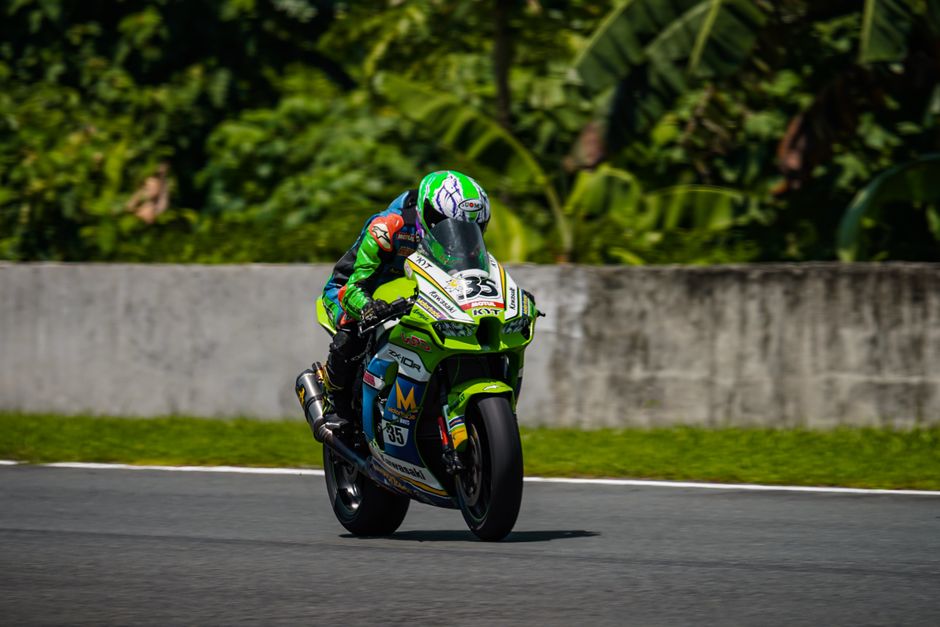 Kawasaki team strategy session in pit lane, detailed cockpit view